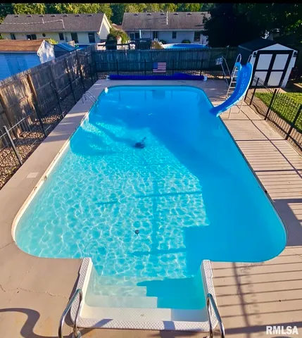 a view of swimming pool outdoor seating and city view