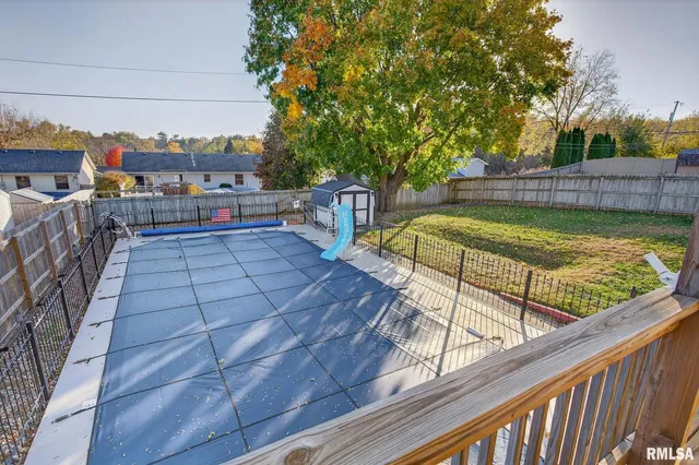 a view of a house with a big yard and sitting area