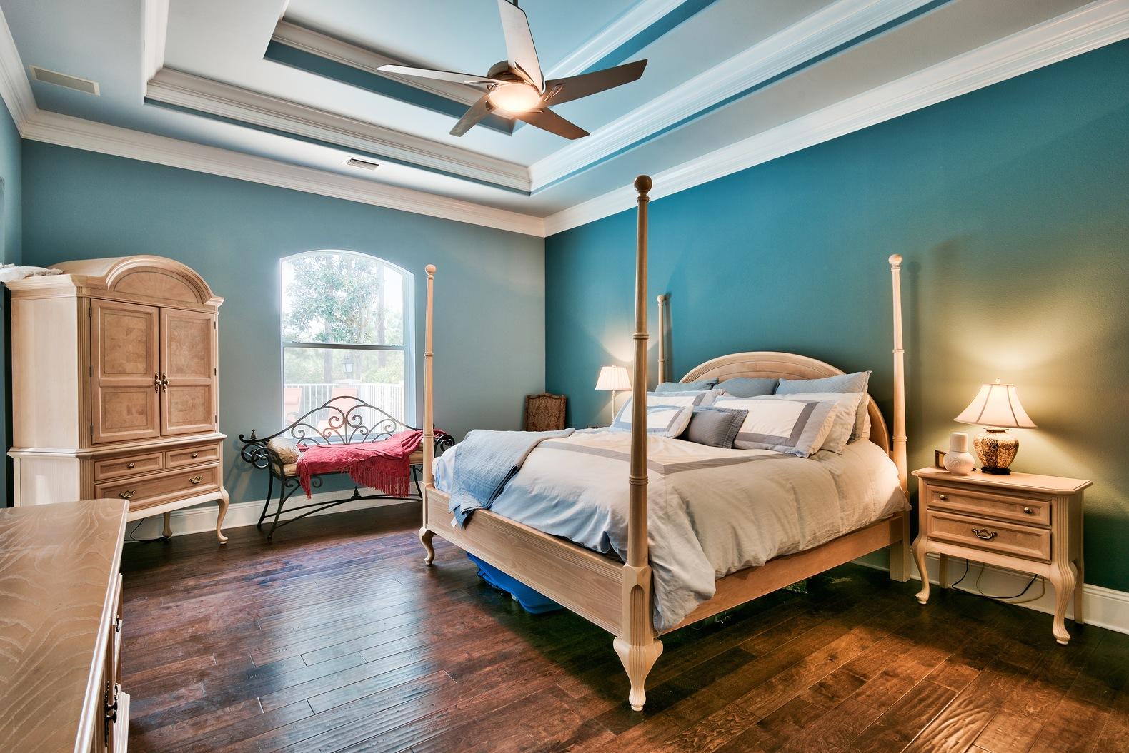 294 Ketch Court Destin, FL 32541 - Photo 15 of 30 a bedroom with a bed and a chandelier