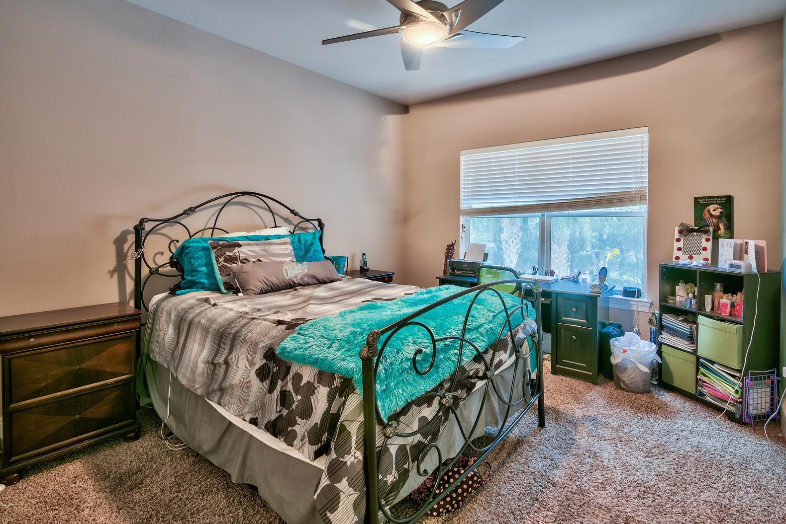 294 Ketch Court Destin, FL 32541 - Photo 21 of 30 a bedroom with a bed a computer on the desk and a book shelf