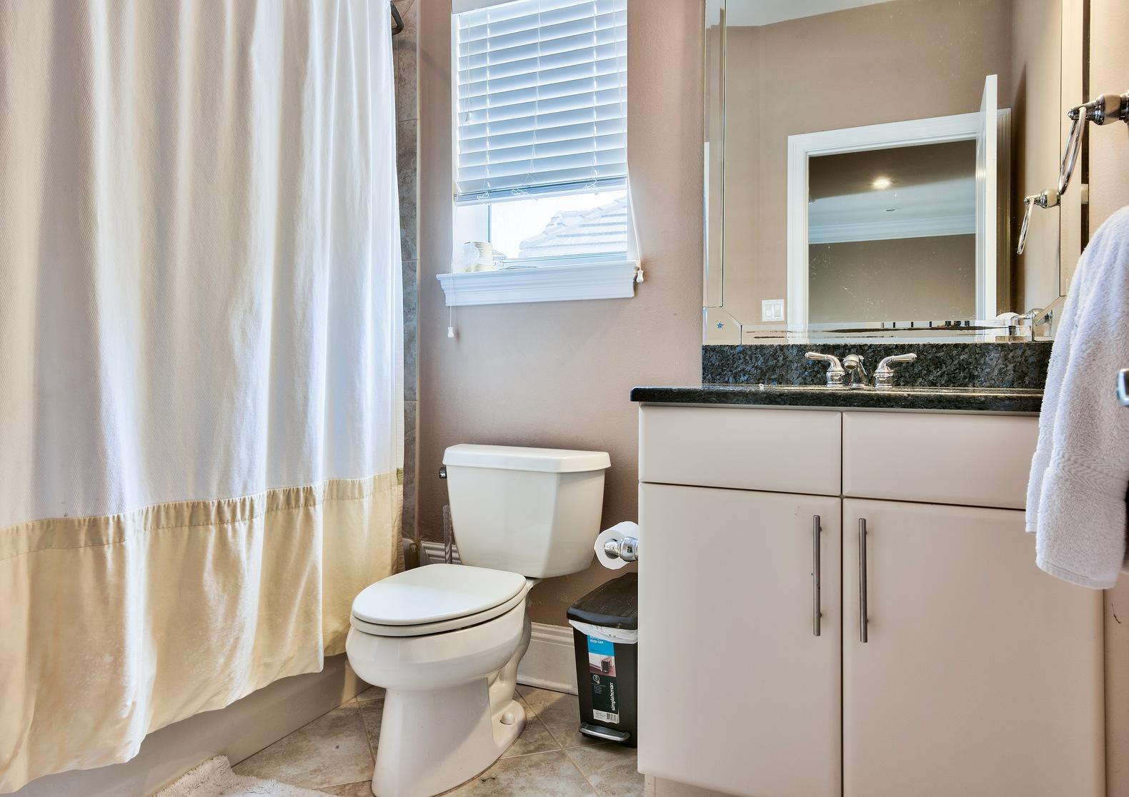 294 Ketch Court Destin, FL 32541 - Photo 22 of 30 a bathroom with a granite countertop toilet a sink and a mirror