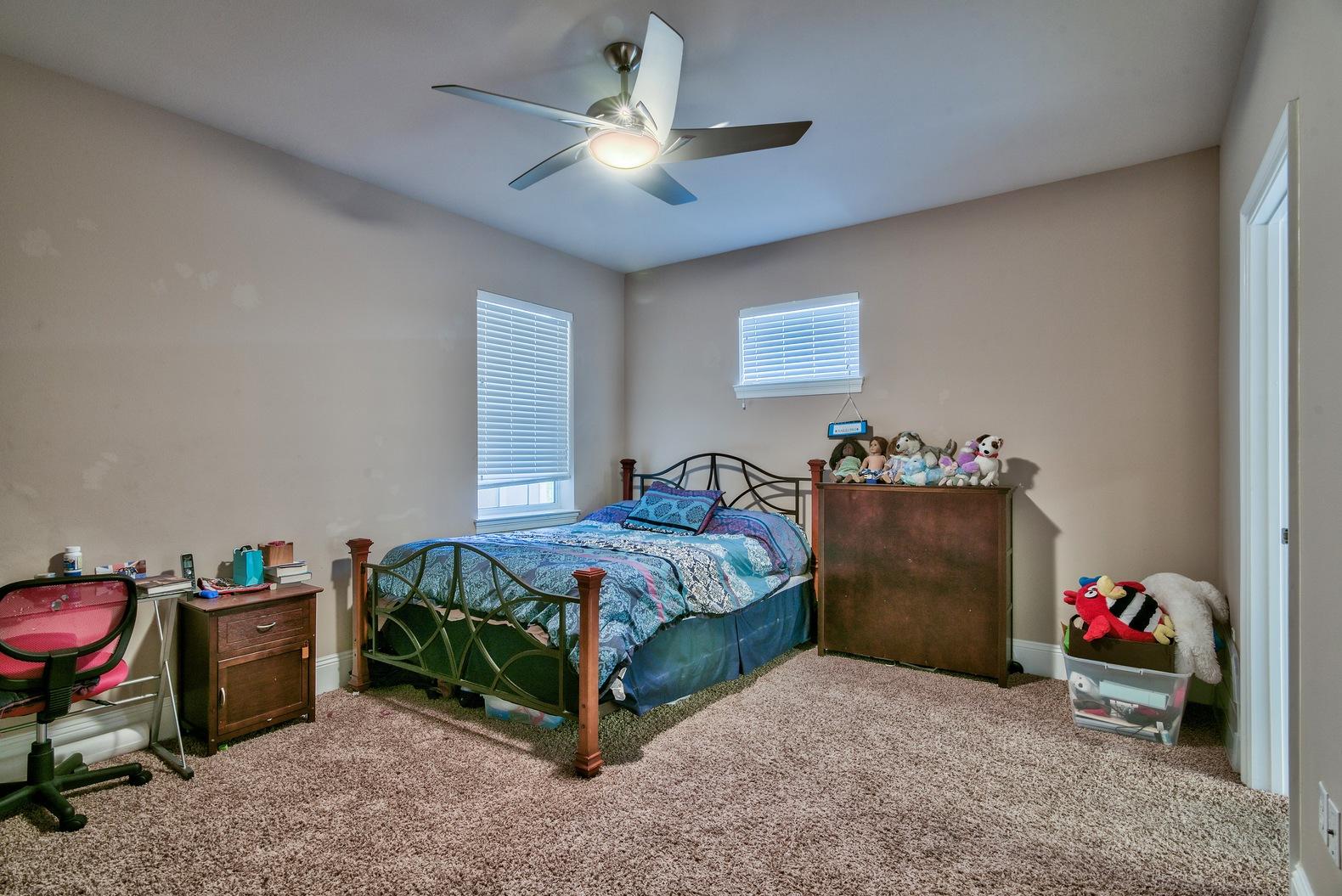 294 Ketch Court Destin, FL 32541 - Photo 23 of 30 a bedroom with a bed and a chandelier