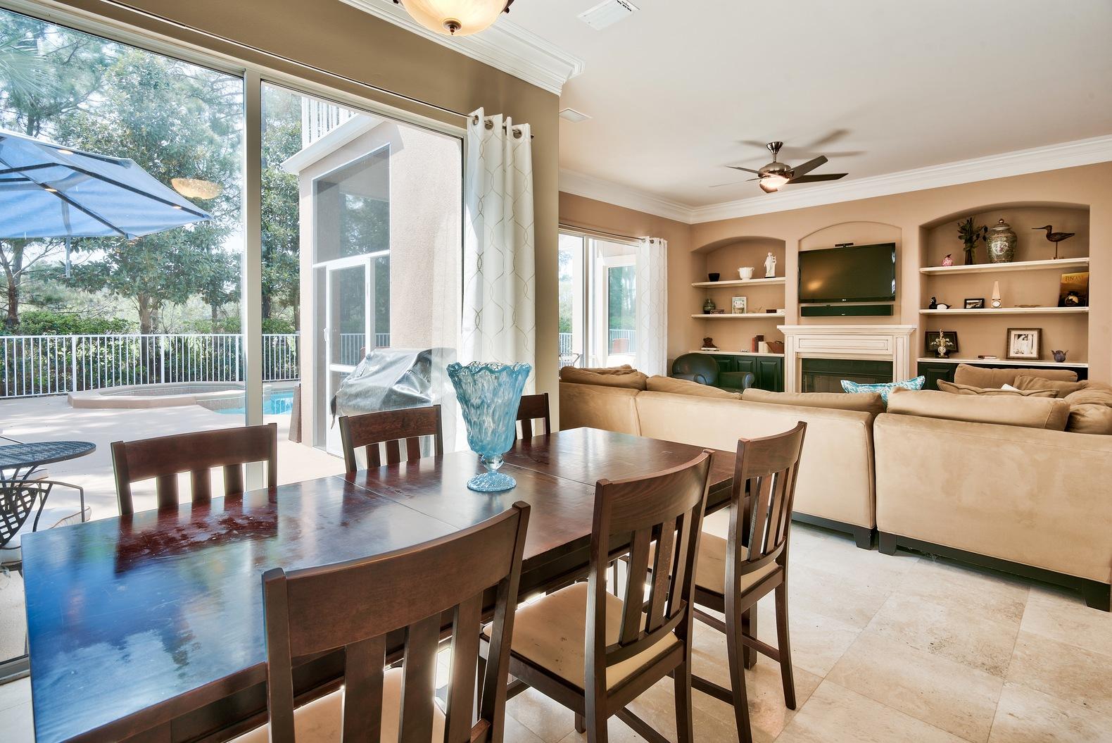 294 Ketch Court Destin, FL 32541 - Photo 7 of 30 a dining room with wooden floor a glass table and chairs