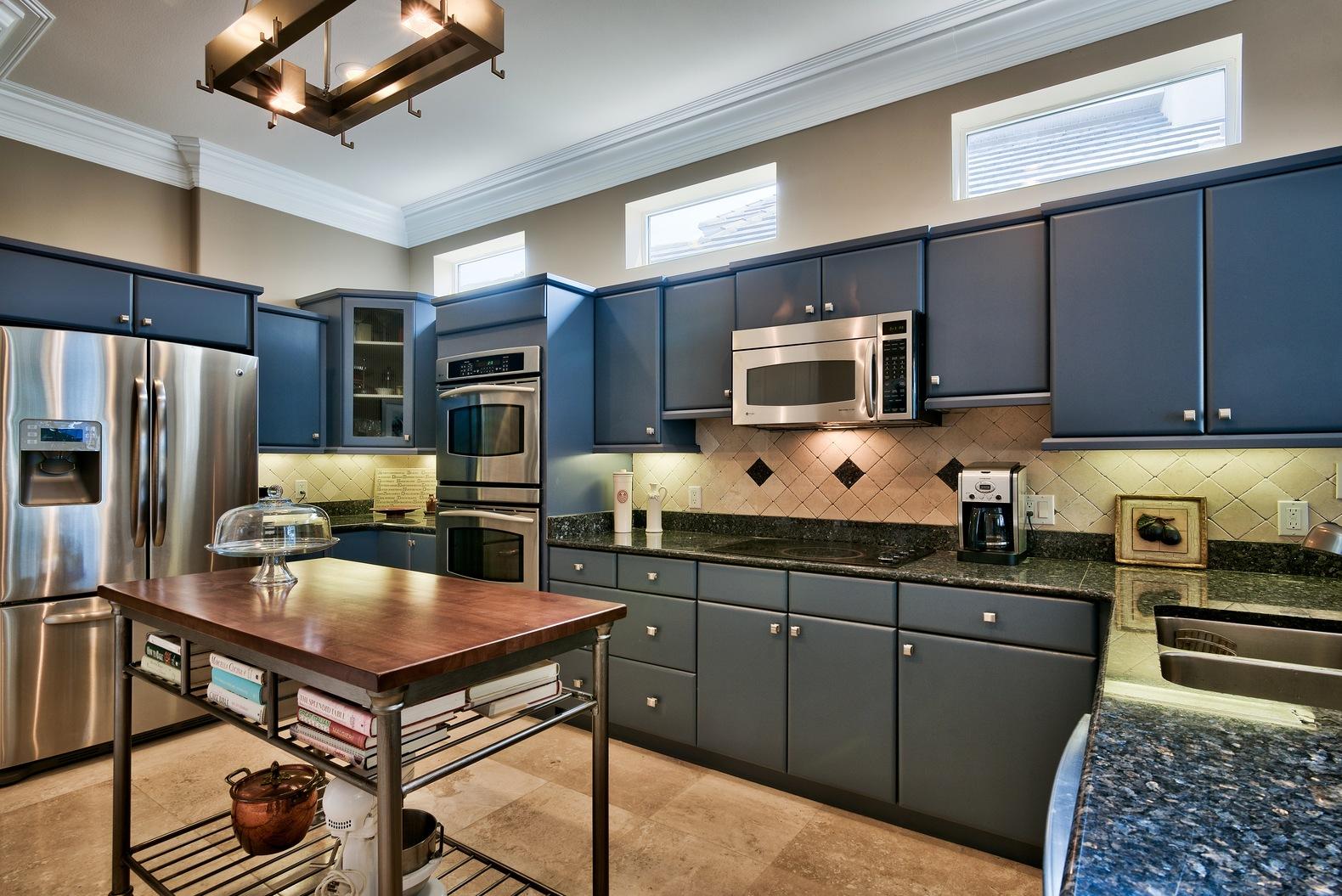 294 Ketch Court Destin, FL 32541 - Photo 10 of 30 a kitchen with stainless steel appliances a stove a sink a microwave a refrigerator and chairs