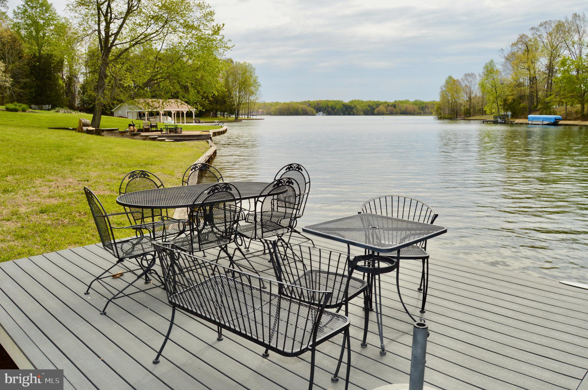 a view of a lake with table and chairs