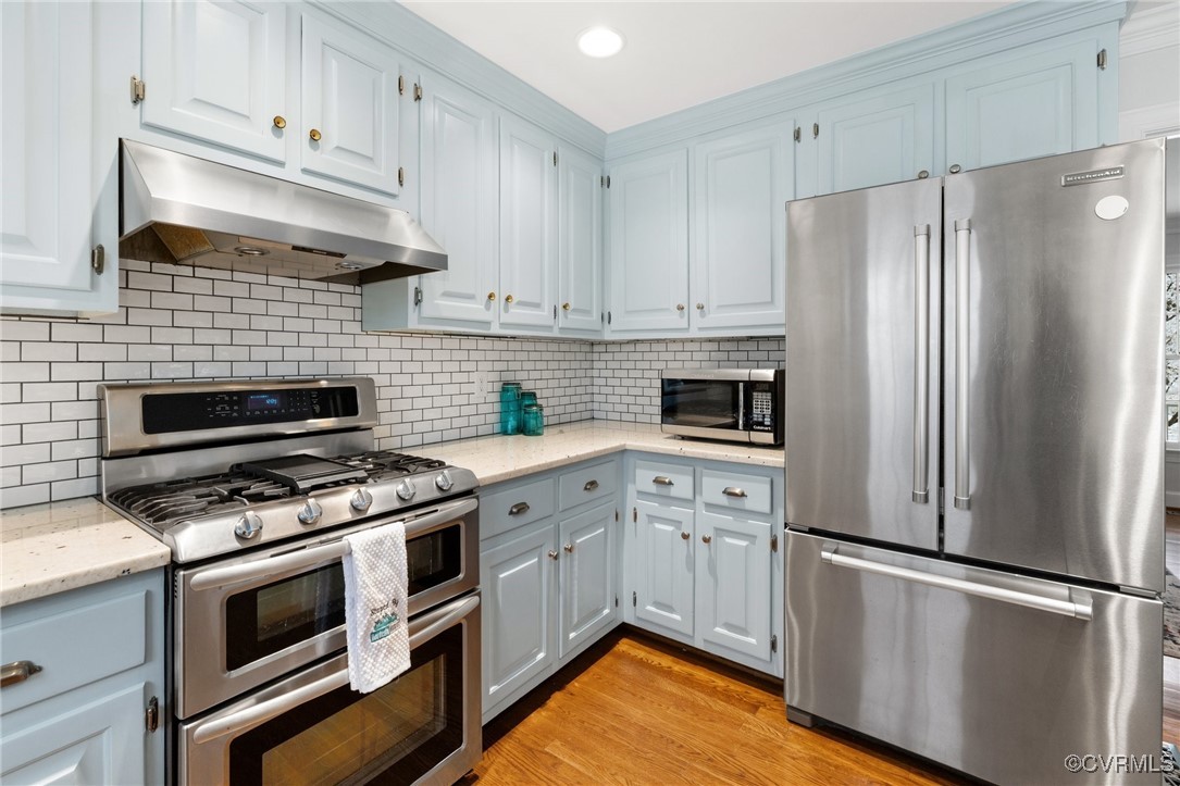 2561 Castle Hill Road Midlothian, VA 23113 - Photo 12 of 46 a kitchen with cabinets stainless steel appliances and wooden floor
