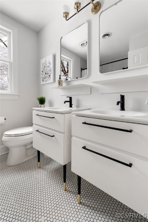 2561 Castle Hill Road Midlothian, VA 23113 - Photo 22 of 46 a bathroom with a sink a toilet and a mirror