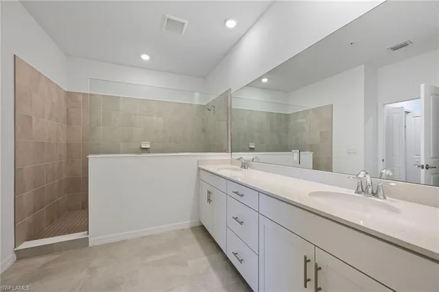 a bathroom with a double vanity sink and mirror