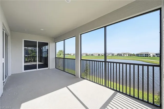 a balcony view with large trees and plants