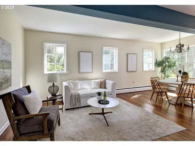 a living room with furniture a dining table and a window