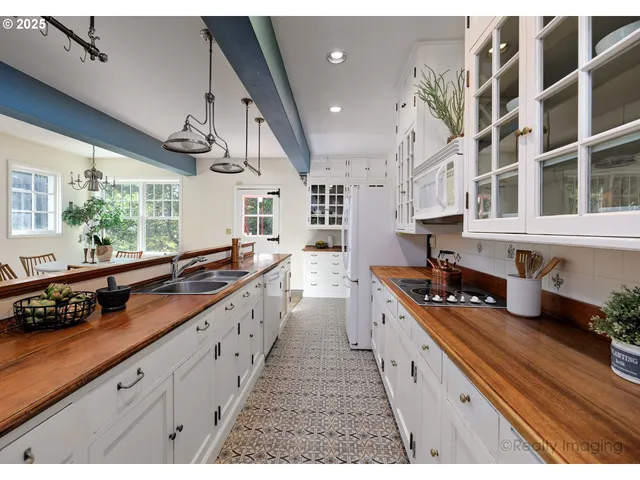 a large kitchen with stainless steel appliances lots of counter space and window