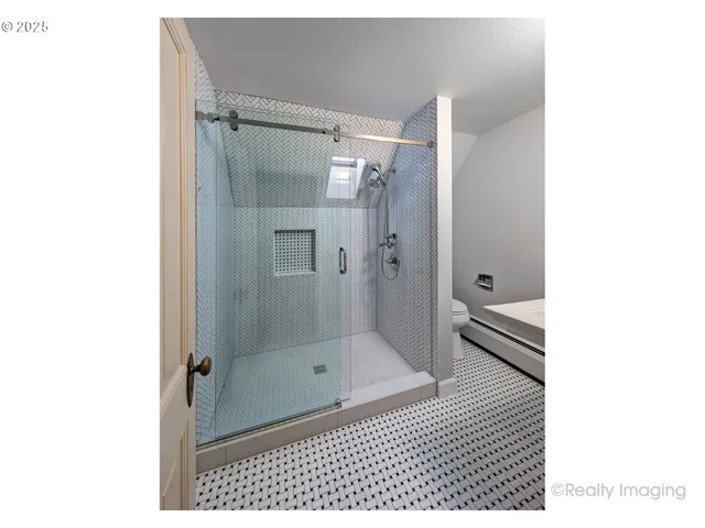 a bathroom with a glass shower door