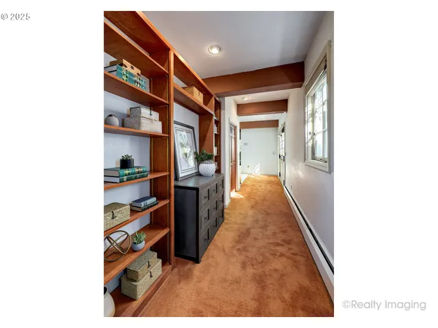 a hallway with a large mirror and closet