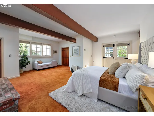 a bedroom with a large bed and window