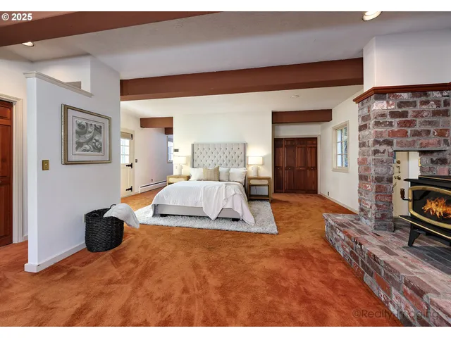 a bedroom with a large bed and a flat screen tv