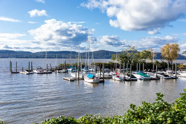 a view of a lake with boats and umbrellas