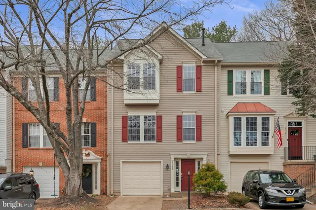 a front view of a residential houses with yard