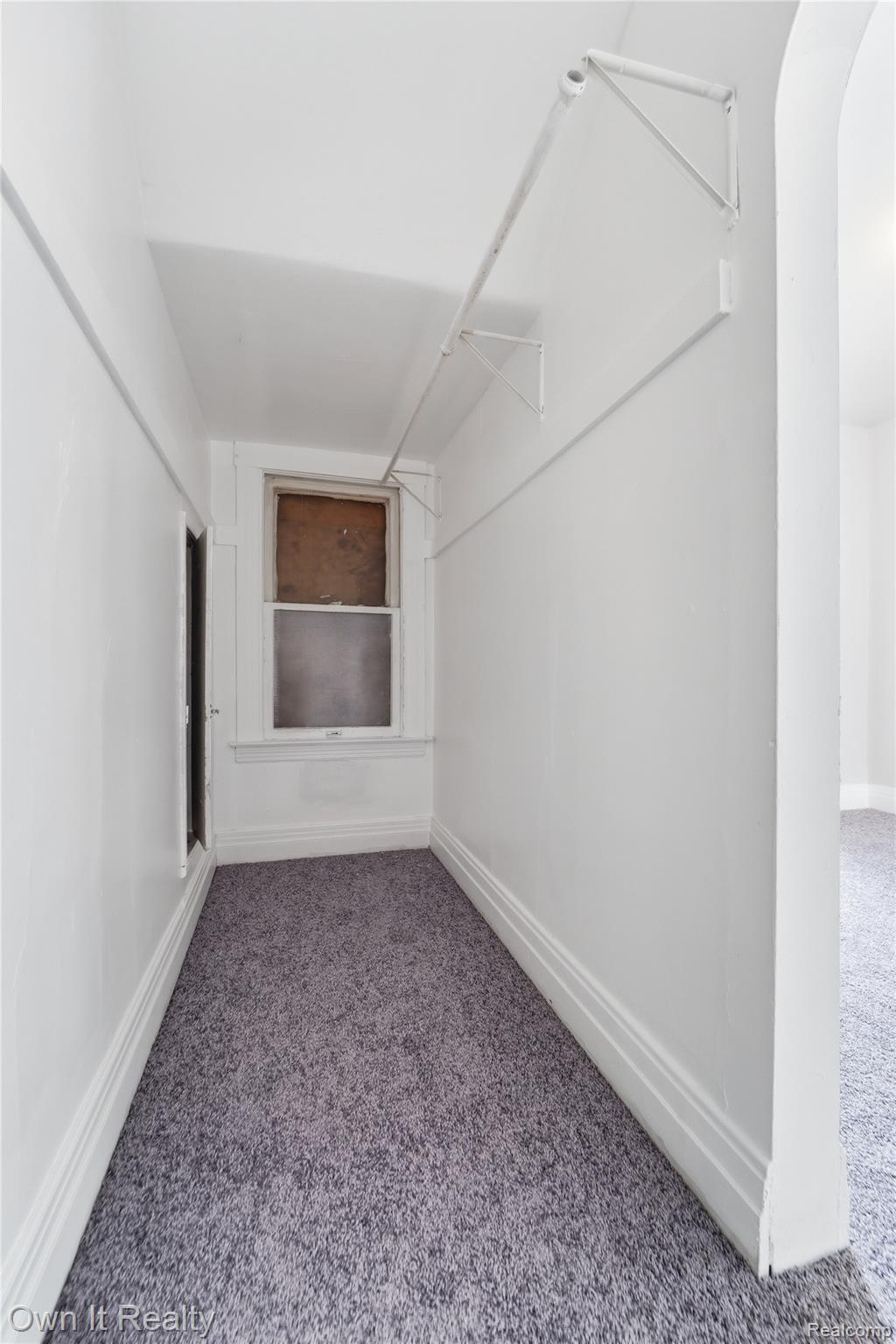 14761 Stephens Road Eastpointe, MI 48021 - Photo 17 of 24 Carpeted hallway with a window, white walls, and white trim