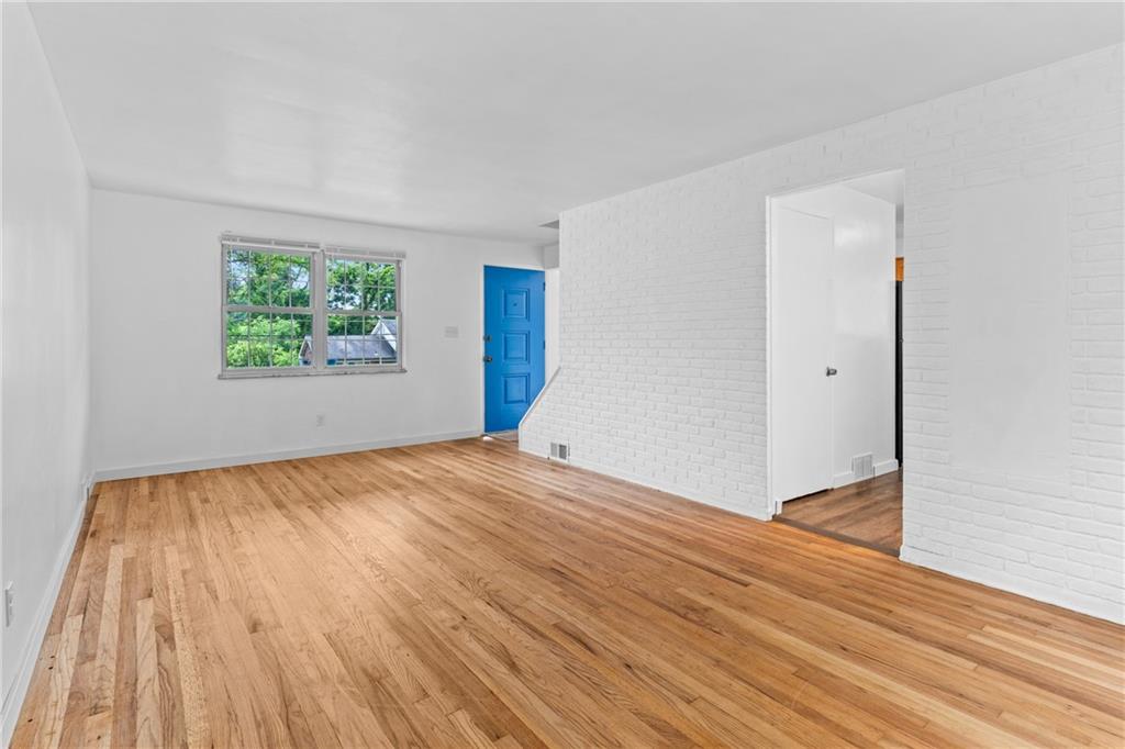 156 Lebeau Pittsburgh, PA 15221 - Photo 11 of 40 a view of empty room with wooden floor and fan