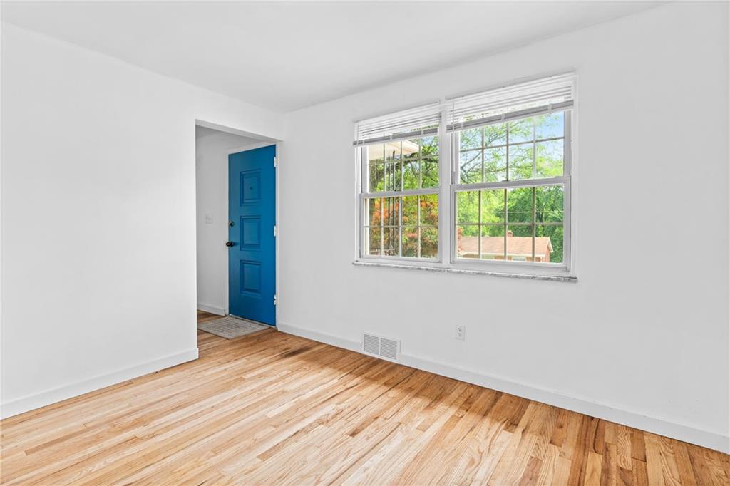 156 Lebeau Pittsburgh, PA 15221 - Photo 12 of 40 a view of an empty room with wooden floor and a window