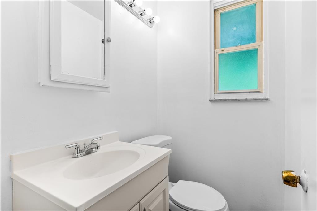 156 Lebeau Pittsburgh, PA 15221 - Photo 16 of 40 a bathroom with a sink a toilet and mirror