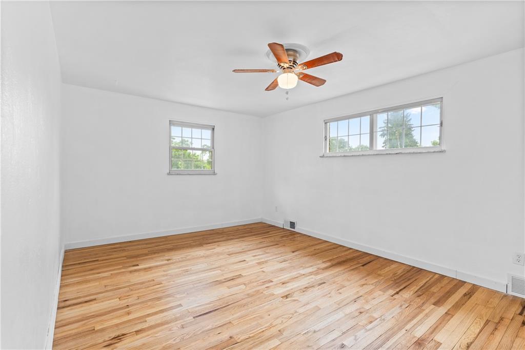 156 Lebeau Pittsburgh, PA 15221 - Photo 17 of 40 a view of empty room with wooden floor and fan