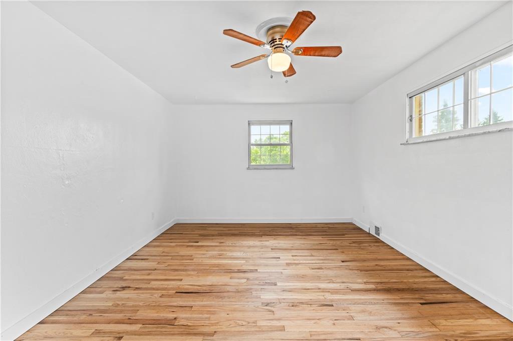 156 Lebeau Pittsburgh, PA 15221 - Photo 18 of 40 an empty room with wooden floor and windows