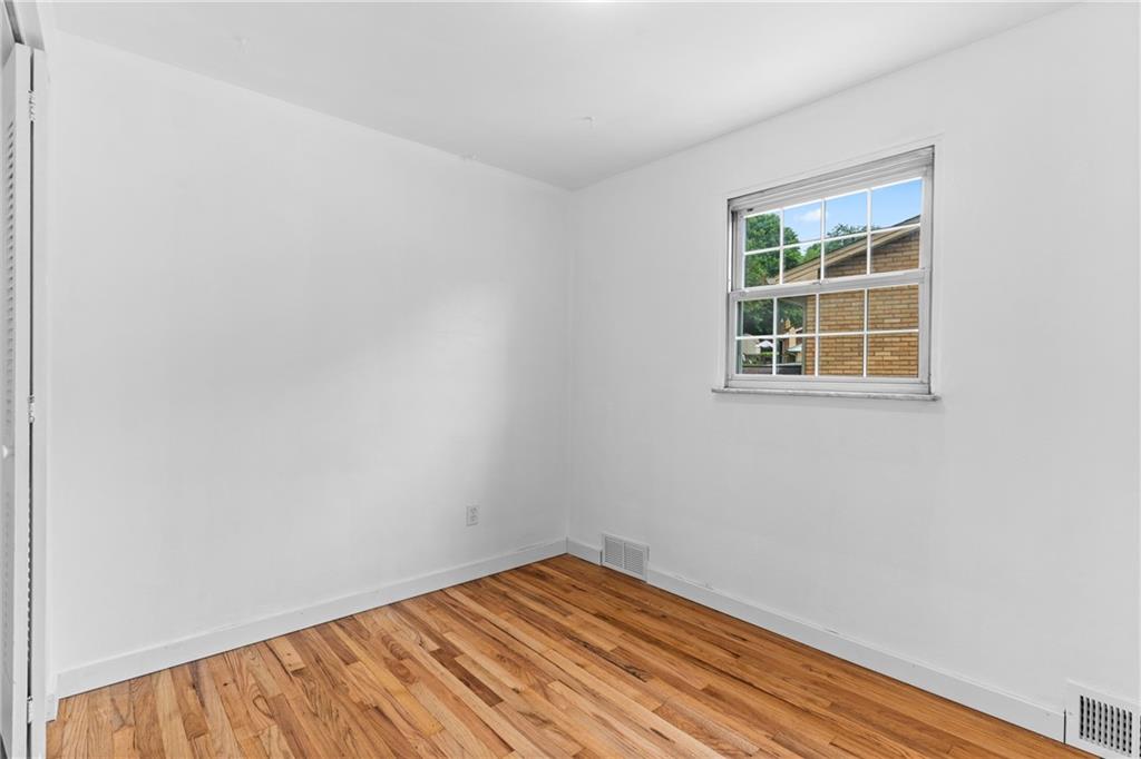 156 Lebeau Pittsburgh, PA 15221 - Photo 27 of 40 an empty room with wooden floor and windows