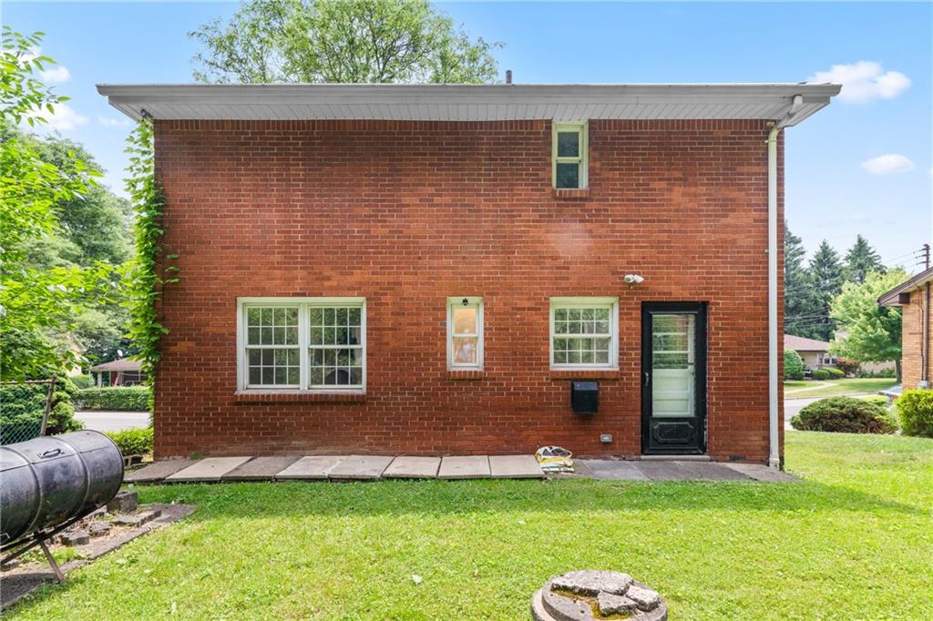 156 Lebeau Pittsburgh, PA 15221 - Photo 33 of 40 a brick house with a yard in front of it