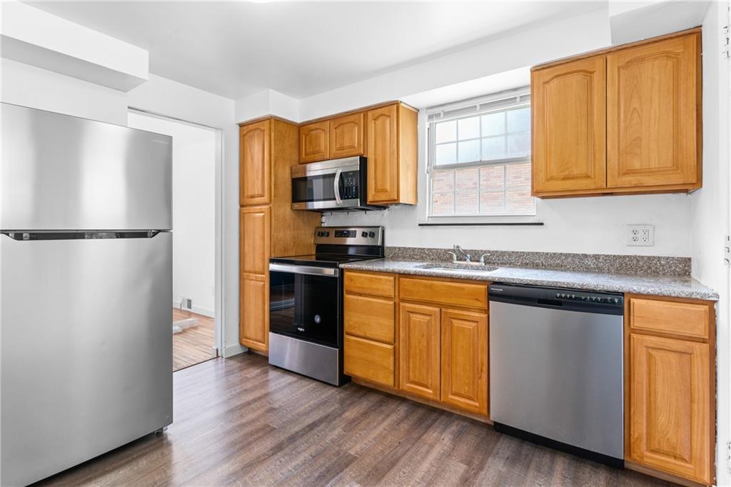 156 Lebeau Pittsburgh, PA 15221 - Photo 4 of 40 a kitchen with granite countertop stainless steel appliances a refrigerator a sink and cabinets