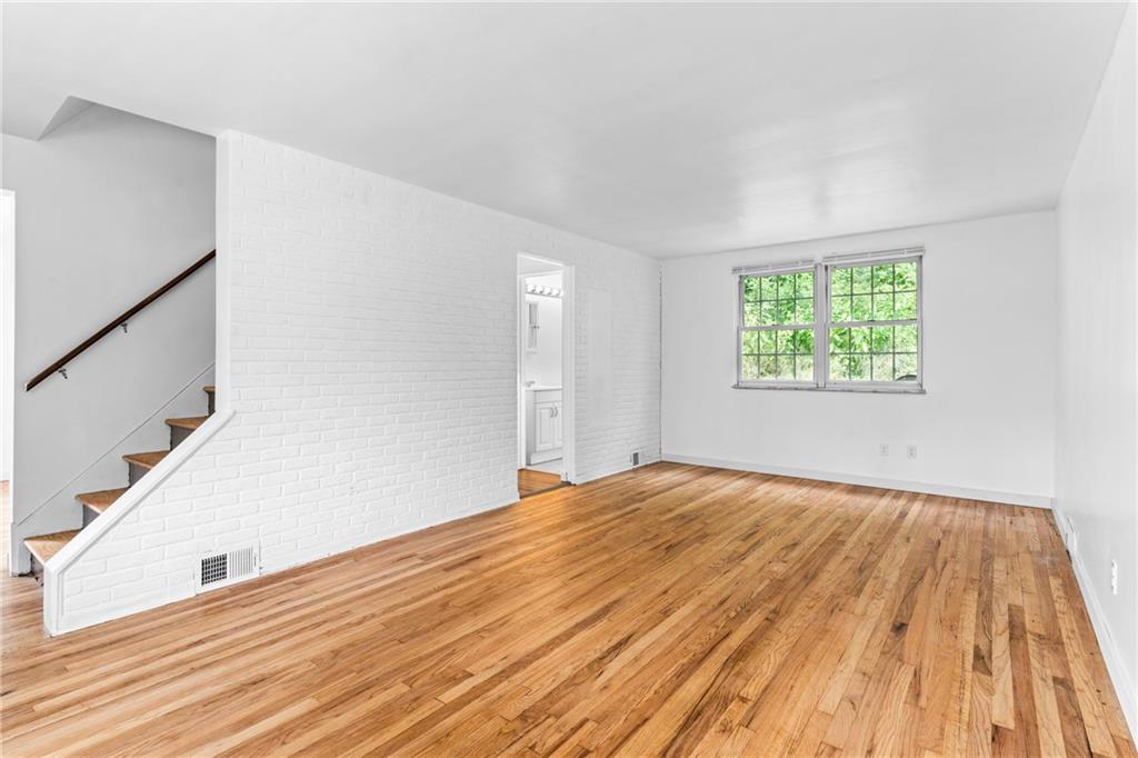 156 Lebeau Pittsburgh, PA 15221 - Photo 9 of 40 a view of an empty room with wooden floor and a window