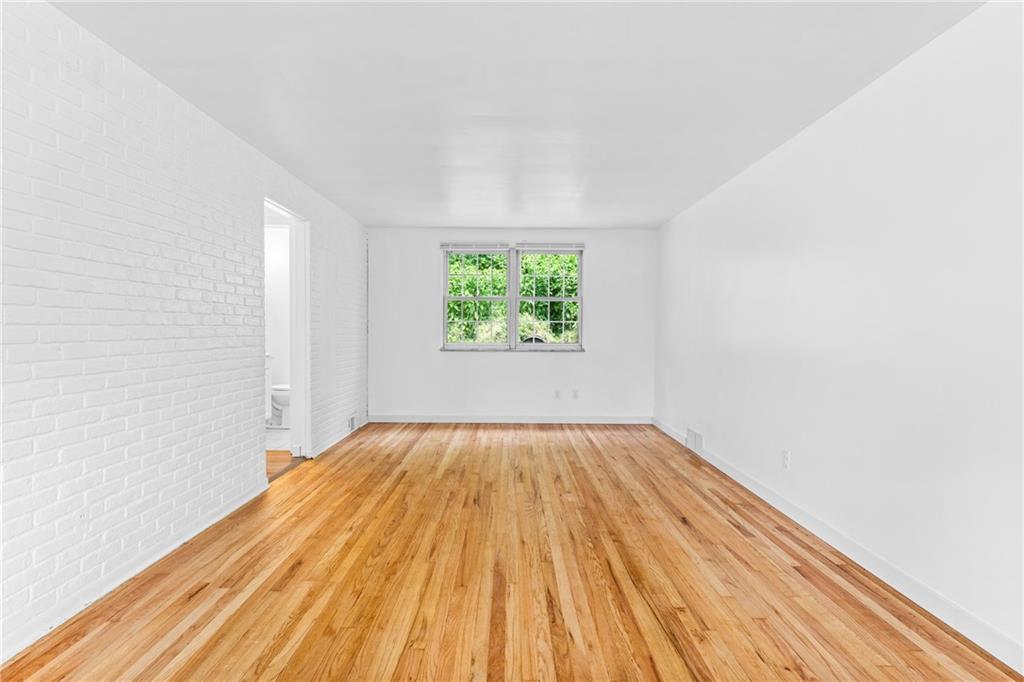 156 Lebeau Pittsburgh, PA 15221 - Photo 10 of 40 an empty room with wooden floor and windows
