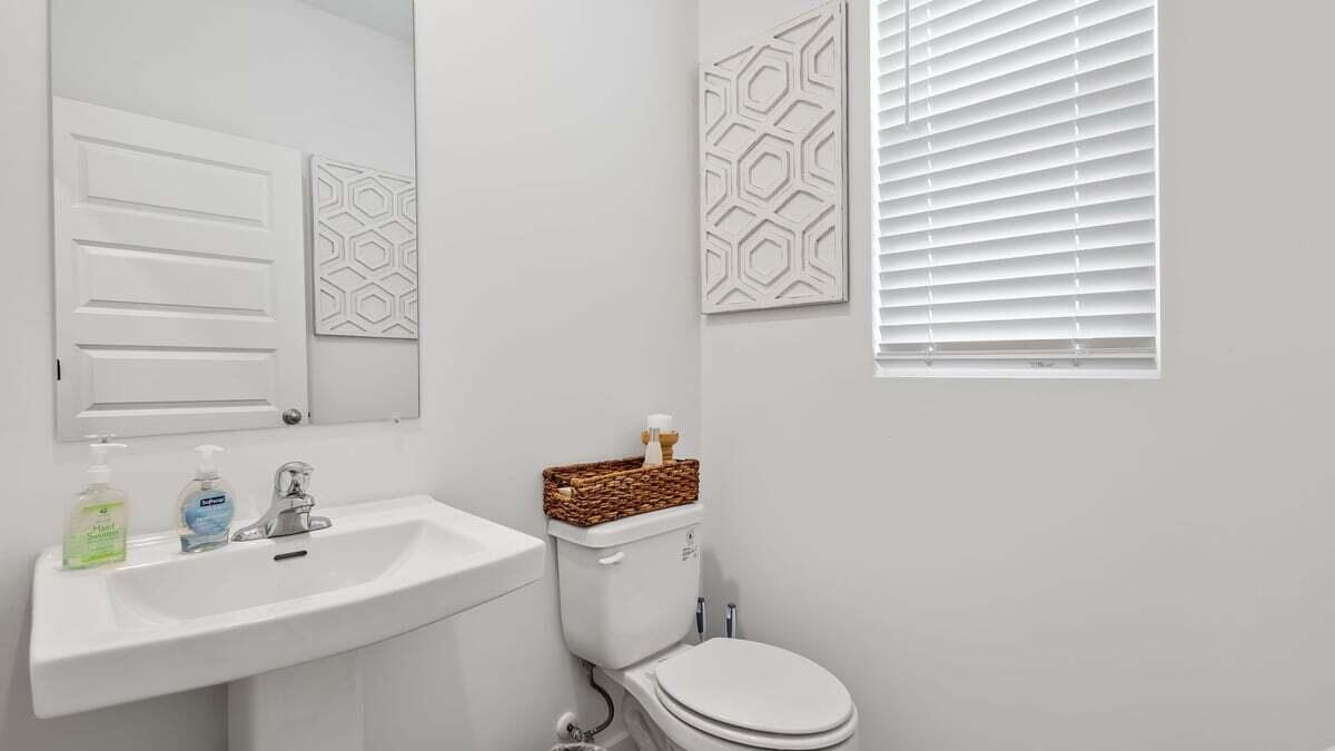 7653 West 106th Place Crown Point, IN 46307 - Photo 11 of 55 a bathroom with a sink mirror and toilet