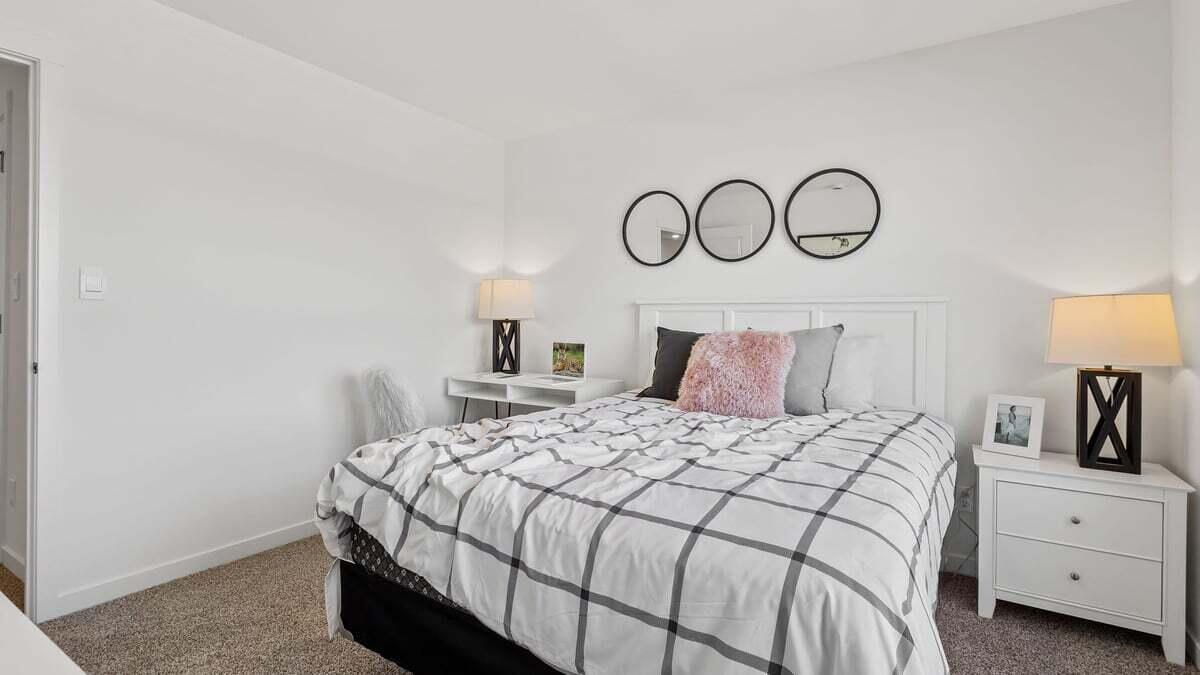 7653 West 106th Place Crown Point, IN 46307 - Photo 20 of 55 a bedroom with a bed and a lamp on dresser