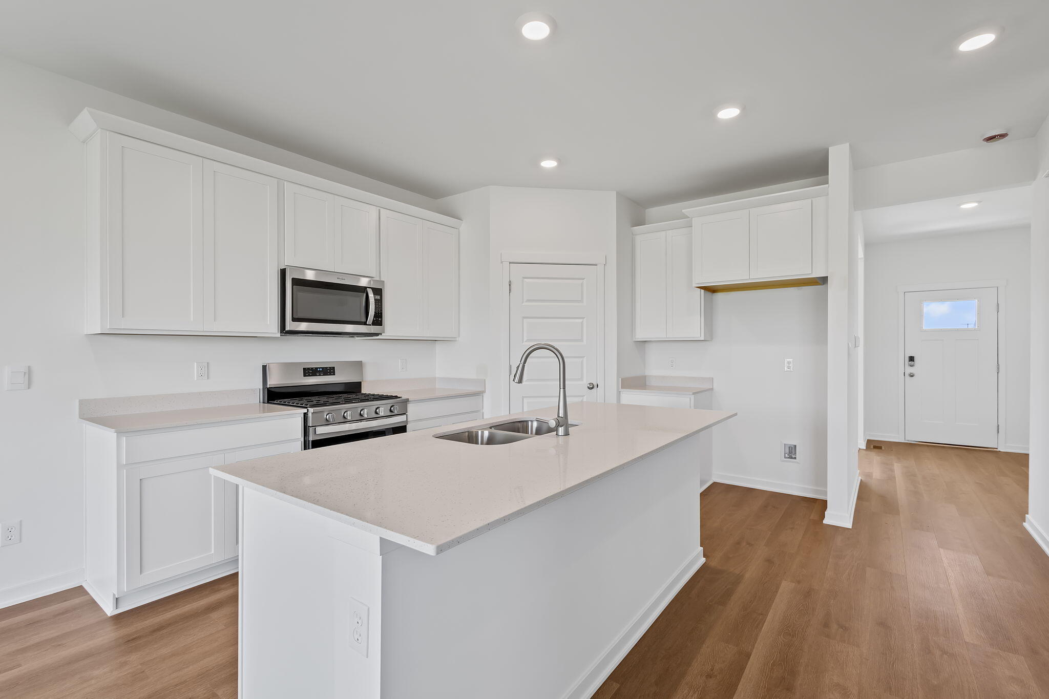 7653 West 106th Place Crown Point, IN 46307 - Photo 27 of 55 a kitchen with appliances a sink a counter space and cabinets