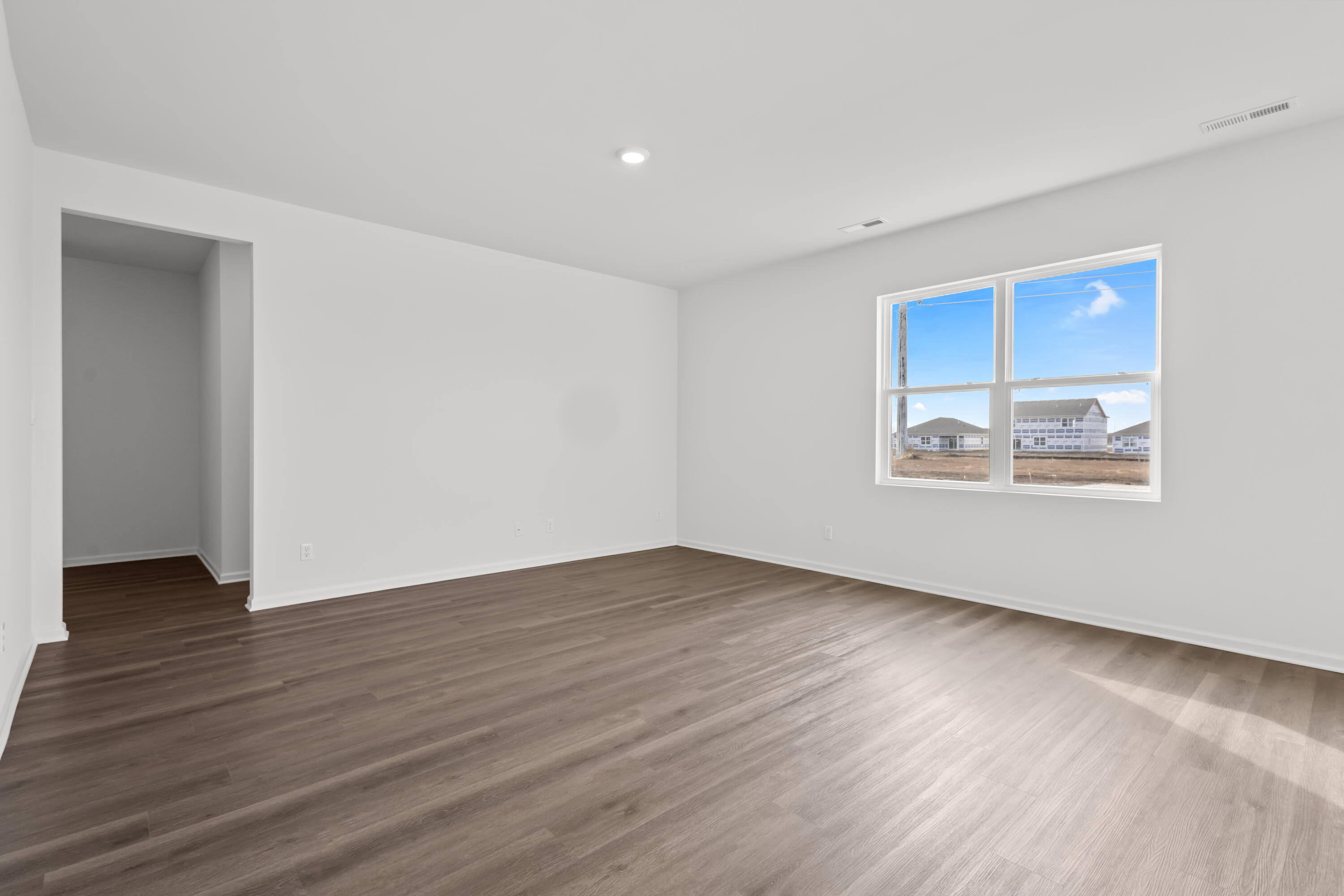 7653 West 106th Place Crown Point, IN 46307 - Photo 36 of 55 a view of an empty room with wooden floor and a window