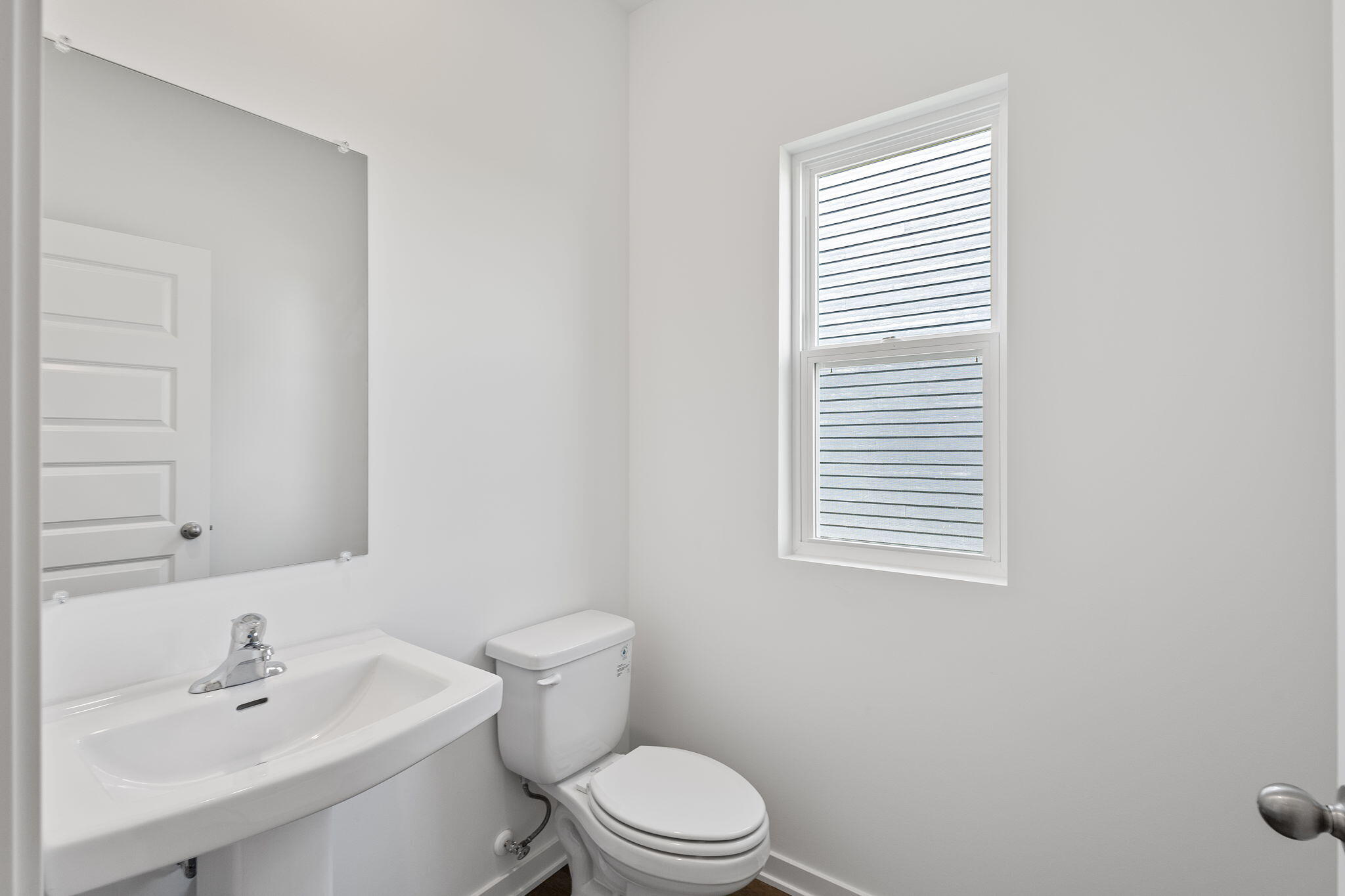 7653 West 106th Place Crown Point, IN 46307 - Photo 38 of 55 a bathroom with a sink a toilet and a mirror