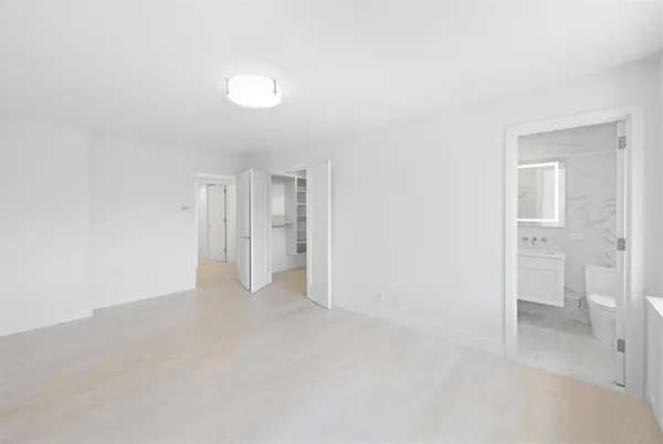 a view of walk in closet with empty racks
