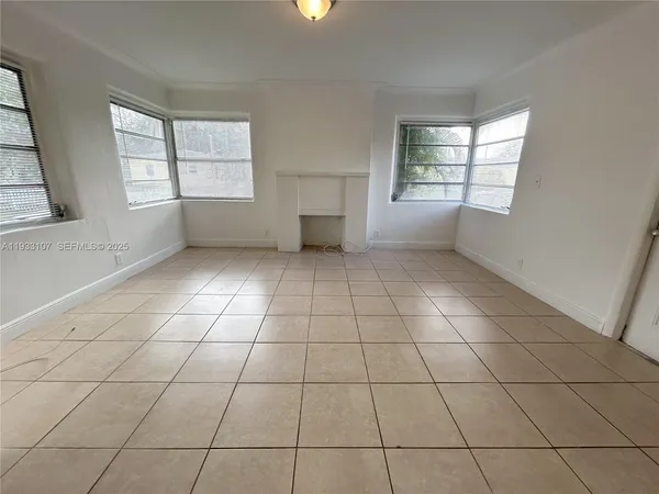 a view of an empty room and closet area