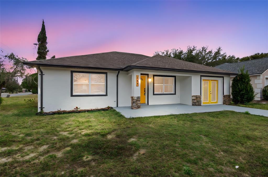 a front view of a house with a garden