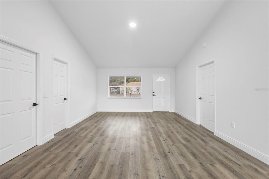 860 South Grove Street Eustis, FL 32726 - Photo 13 of 54 an empty room with wooden floor and windows