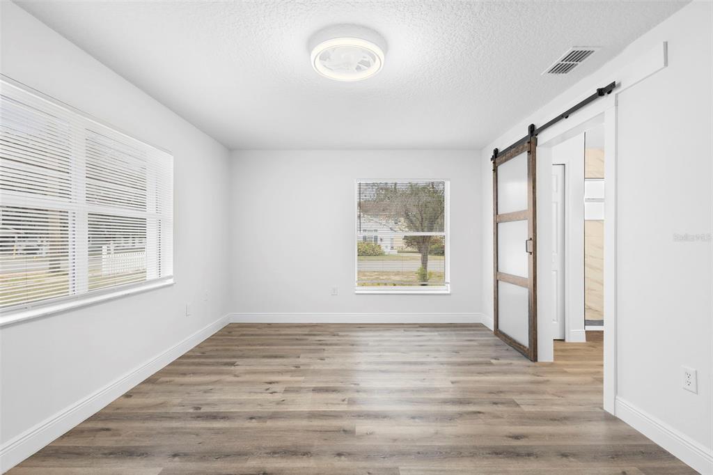 860 South Grove Street Eustis, FL 32726 - Photo 20 of 54 a view of an empty room with a window and wooden floor