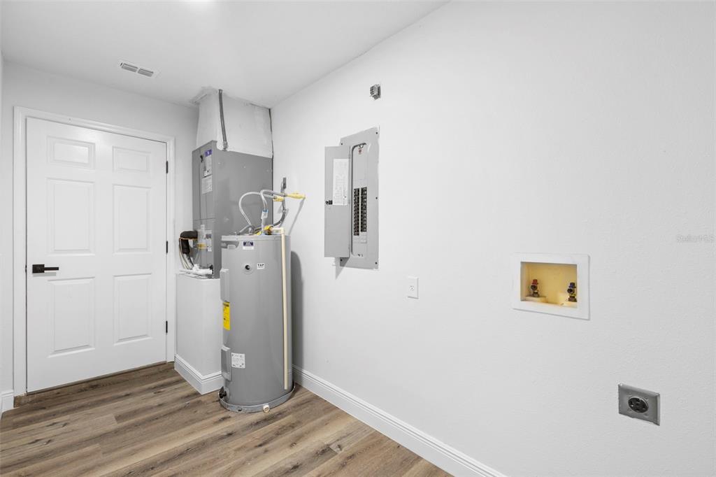 860 South Grove Street Eustis, FL 32726 - Photo 27 of 54 a view of storage and utility room with wooden floor