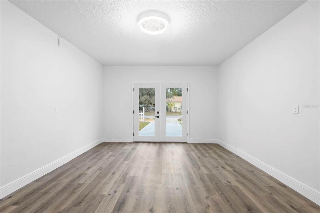 860 South Grove Street Eustis, FL 32726 - Photo 29 of 54 a view of a room with wooden floor and window