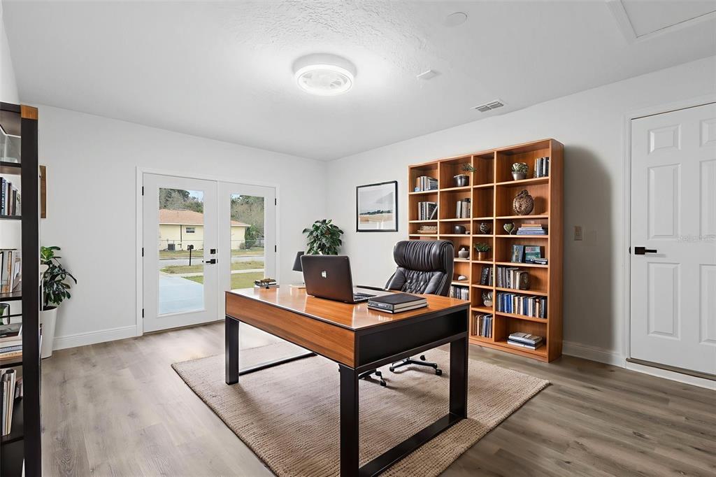 860 South Grove Street Eustis, FL 32726 - Photo 32 of 54 a work room with furniture and wooden floor