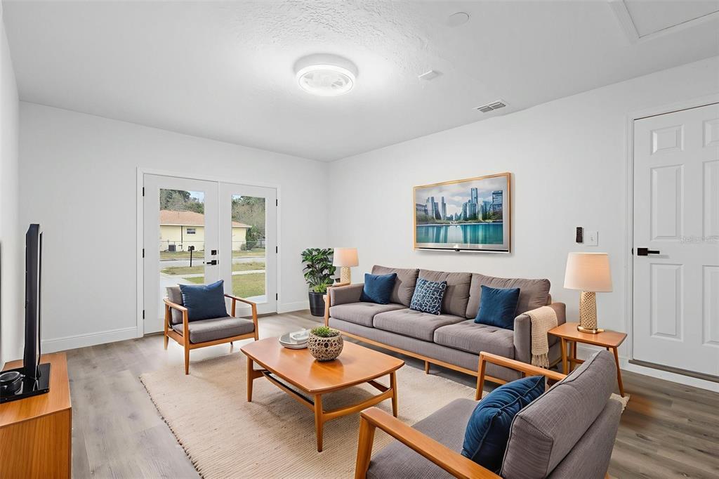 860 South Grove Street Eustis, FL 32726 - Photo 33 of 54 a living room with furniture a rug and a window