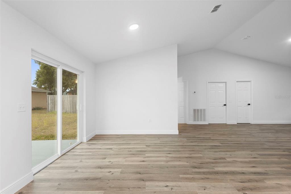 860 South Grove Street Eustis, FL 32726 - Photo 37 of 54 a view of an empty room with wooden floor and a window