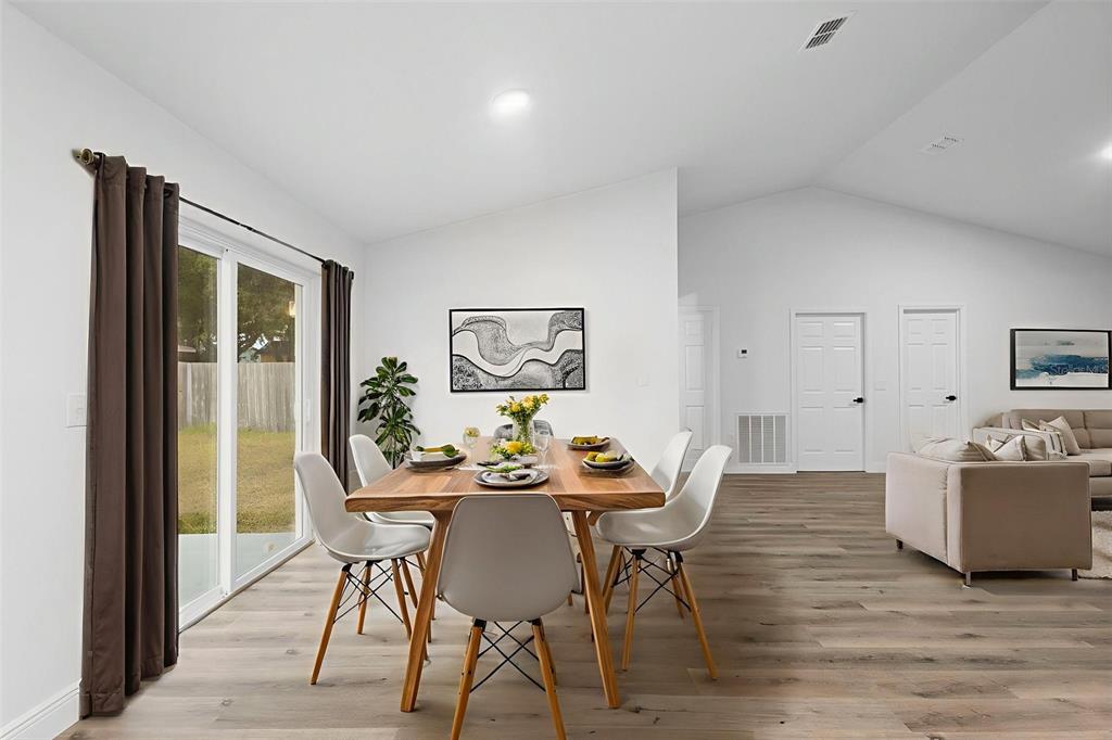 860 South Grove Street Eustis, FL 32726 - Photo 38 of 54 a view of a dining room with furniture window and wooden floor