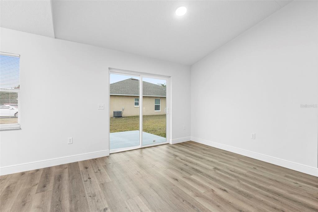 860 South Grove Street Eustis, FL 32726 - Photo 41 of 54 an empty room with wooden floor and closet