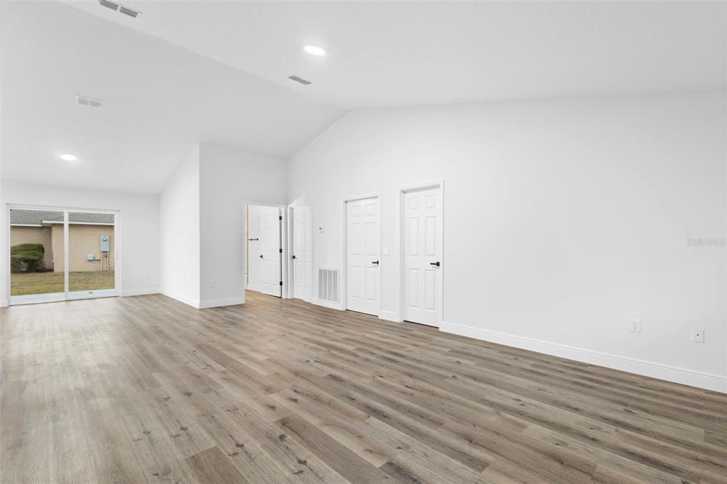 860 South Grove Street Eustis, FL 32726 - Photo 43 of 54 a view of an empty room with wooden floor and windows